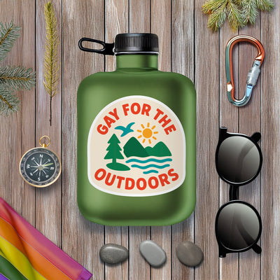 Gay For the Outdoors Sticker with mountains sunshine and nature illustration surrounded by pride flag and outdoor products