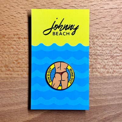 Suns Out Buns Out enamel pin with man in thong illustration