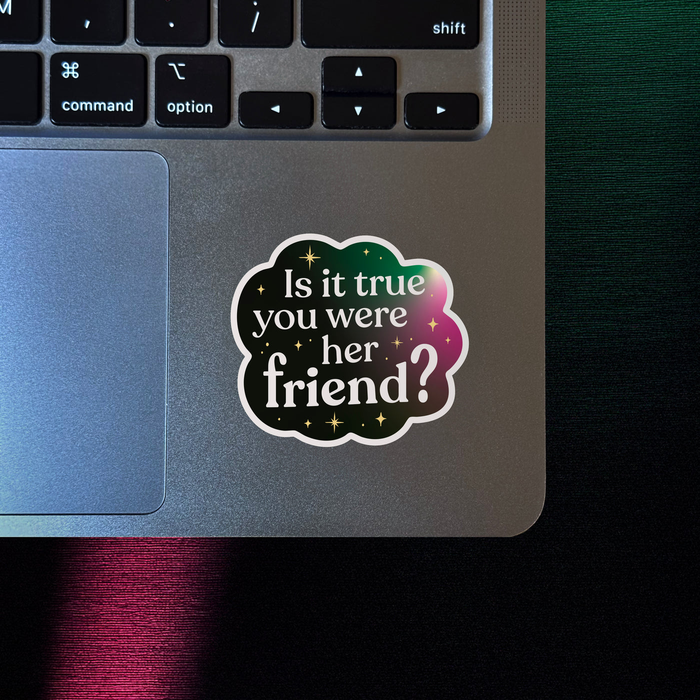 Broadway-inspired vinyl sticker with a quote about friendship, on a silver laptop for queer theater fans