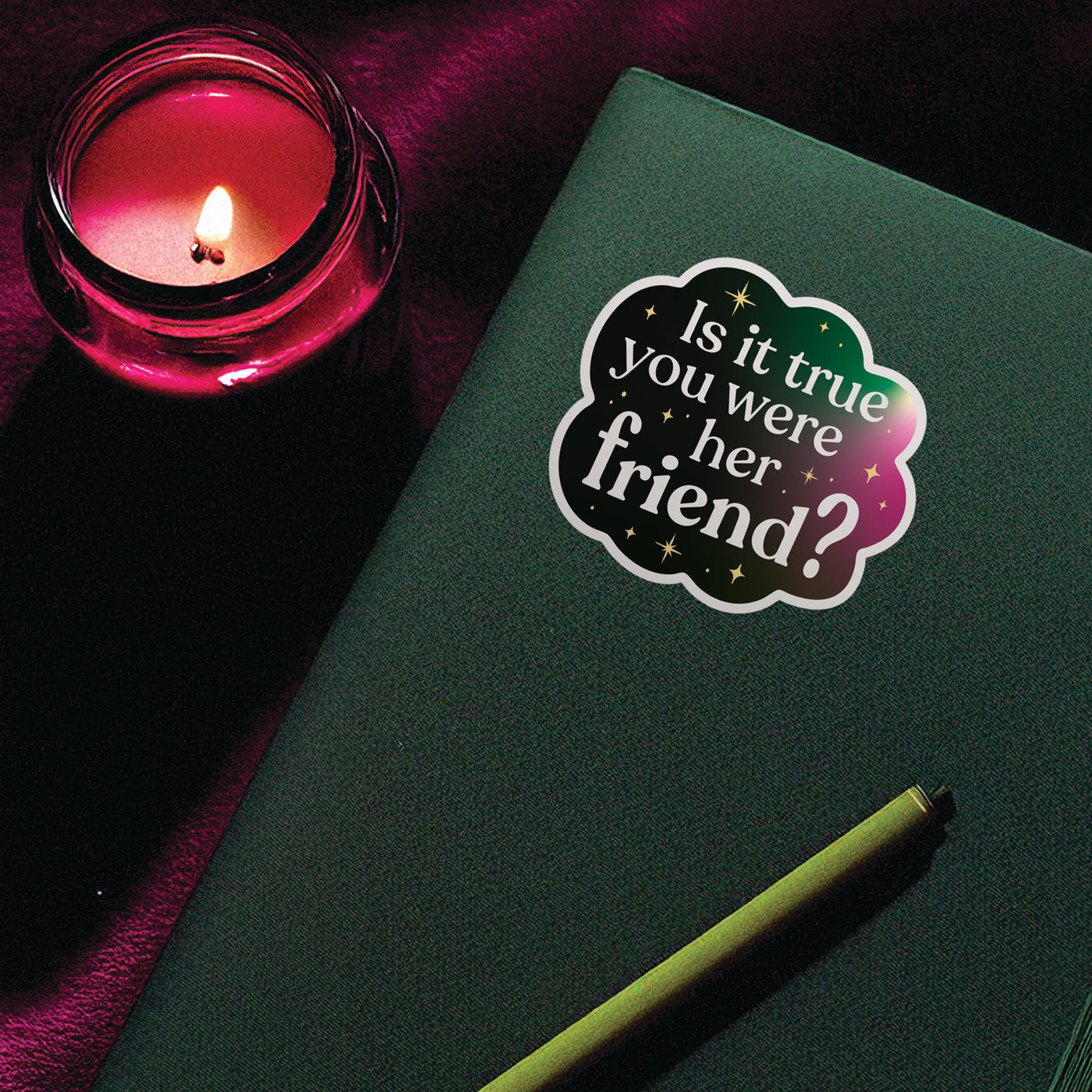 Broadway-inspired vinyl sticker on a notebook with candle nearby, moody and magical aesthetic for queer theater fans